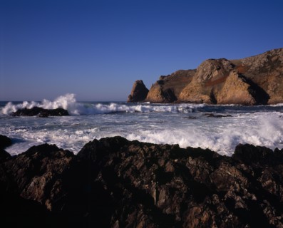 UNITED KINGDOM, Channel Islands, Jersey, St Ouen. Le Pulec. Rough sea with waves crashing against