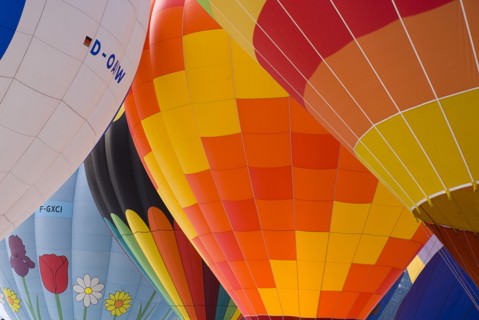 SWITZERLAND, Canton de Vaud, Chateau d'Oex, Inflated Hot Air Balloons with prominent flower pattern