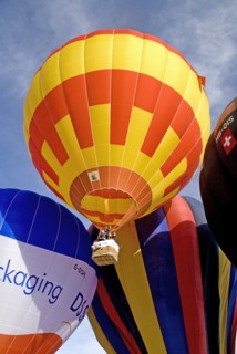 SWITZERLAND, Canton de Vaud, Chateau d'Oex, Hot Air Balloon taking off with people in basket