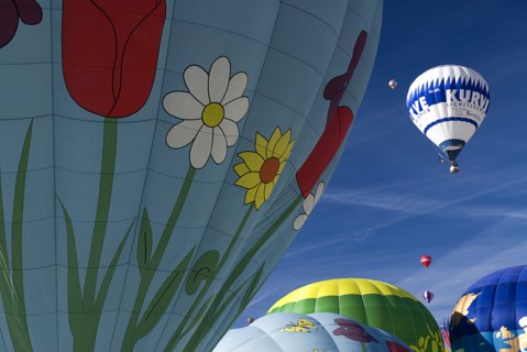 SWITZERLAND, Canton de Vaud, Chateau d'Oex, Three Hot Air Balloons taking off and framed by