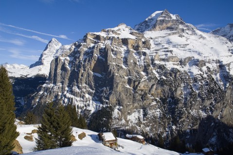 SWITZERLAND, Bernese Oberland, Murren, Houses on cliff edge with Eiger and Monch mountains in