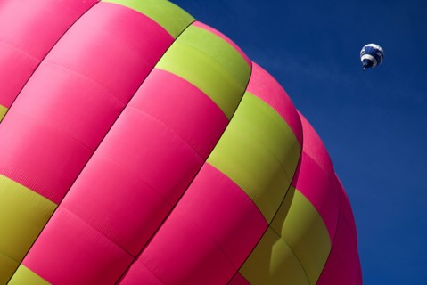 SWITZERLAND, Canton de Vaud, Chateau d'Oex, Section of Hot Air Balloon on ground as another balloon