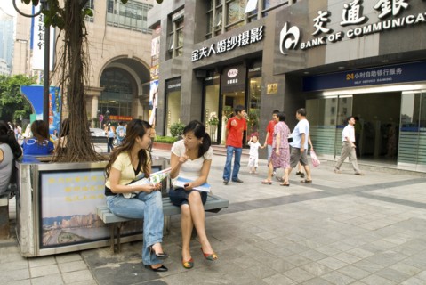 CHINA, Sichuan Province, Chongqing, Shoppers chatting in downtown. Chongqing is China's largest