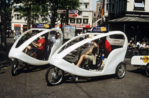 HOLLAND, Amsterdam , Wieler taxis and tourists waiting in a square