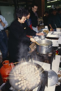 ENGLAND, London, Chinese New Year, Women cooking on street stall during New Year celebrations in
