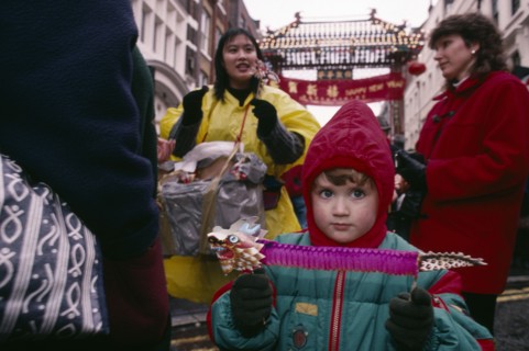 ENGLAND, London, Chinese New Year, "Young non-Chinese child holding paper lion during Chinese New