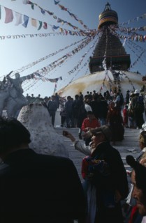 NEPAL, Kathmandu, Bodhanath, Crowd of Tibetans offering incense on the steps of the main stupa