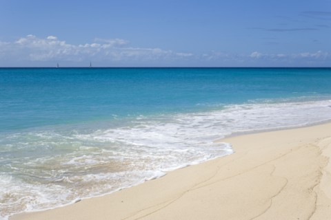 WEST INDIES, St Vincent And The Grenadines, Canouan, South Glossy Beach in Glossy Bay with waves