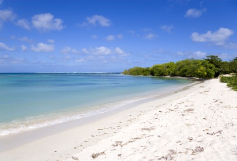 WEST INDIES, Grenada, Carriacou, Waves breaking on Paradise Beach at L'Esterre Bay with the