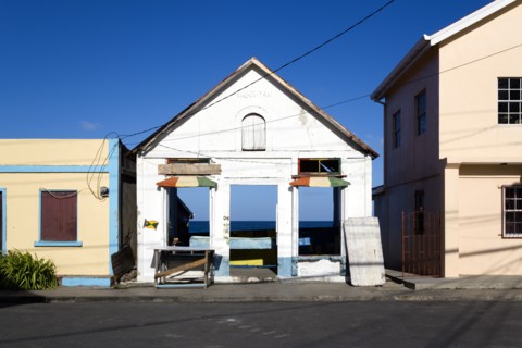 WEST INDIES, Grenada, Carriacou, Derelict building in the main street of Hillsborough with the