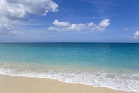 WEST INDIES, Grenada, St George, Waves breaking on the shore at Grand Anse Beach with the turquoise