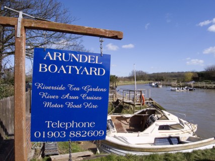 ENGLAND, West Sussex, Arundel, Sign for boatyard on the riverbank.