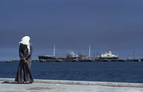 KUWAIT, Mina Ahmadi , Man wearing a white headscarf looking out across the sea towards the Mina