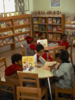 KUWAIT, Education, Kindergarten class with children sitting around tables reading books