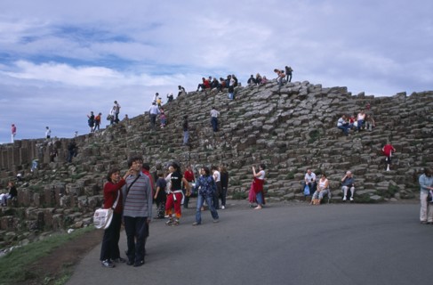 NORTHERN IRELAND, County Antrim, Giants Causeway, Visitors walking over the interlocking basalt