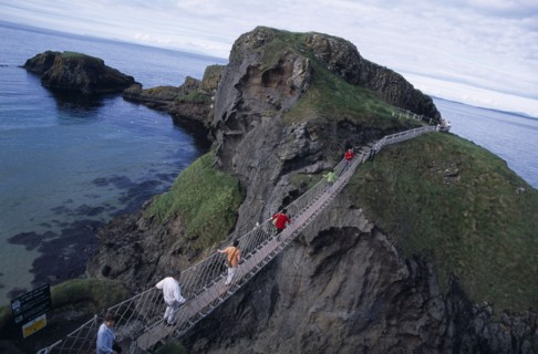 NORTHERN IRELAND, County Antrim, Ballintoy, Carrick-a-Rede Rope Bridge. Vistors walking over rope