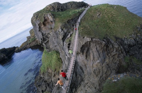 NORTHERN IRELAND, County Antrim, Ballintoy, Carrick-a-Rede Rope Bridge. Vistors walking over rope