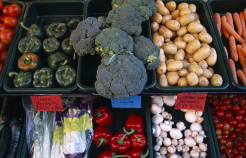 ENGLAND, East Sussex, Hastings, Vegetables in trays outside greengrocers shop.