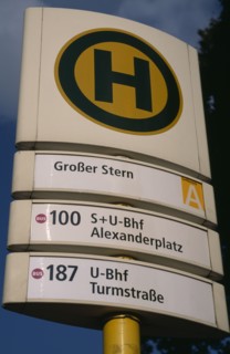 GERMANY, Berlin, Bus and tram stop sign  green H within yellow circle stands for Haltestelle or