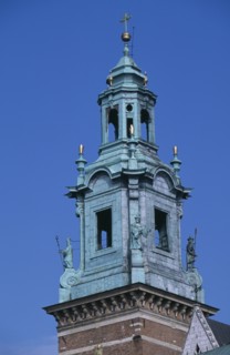 POLAND, Krakow, Detail of church clock tower of Wawel Cathedral with statues positioned at four