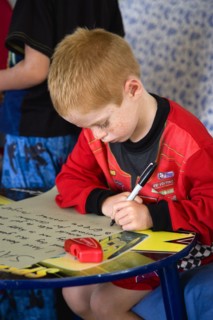 RELIGION, Festivals, Christmas, Young left handed boy at Christmas Eve sitting down and writing his