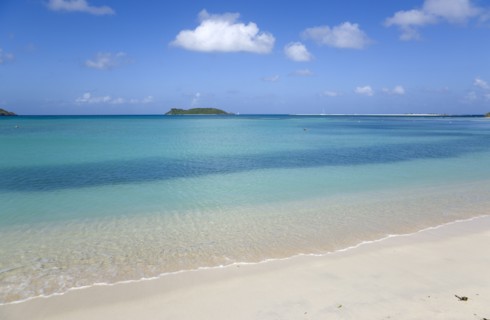 WEST INDIES, Grenada, Carriacou, The calm clear blue water breaking on Paradise Beach in L'Esterre
