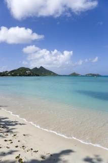 WEST INDIES, Grenada, Carriacou, The calm clear blue water breaking on Paradise Beach in L'Esterre