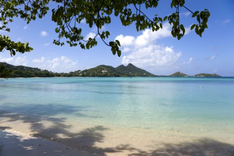 WEST INDIES, Grenada, Carriacou, The calm clear blue water breaking on Paradise Beach in L'Esterre