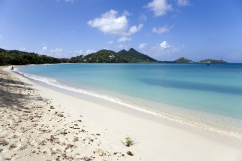 WEST INDIES, Grenada, Carriacou, Single person at the waters edge of the calm clear blue water