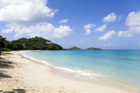 WEST INDIES, Grenada, Carriacou, The calm clear blue water breaking on Paradise Beach in L'Esterre