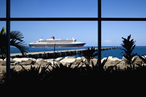 WEST INDIES, Grenada, St George, The Queen Mary 2 liner at anchor beyond a jetty off the capital