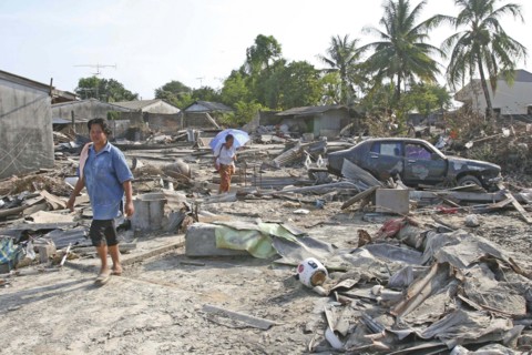 THAILAND, Phang Nga District, Nam Khem, "Tsunami. Thais walk through what is left of there vilage,