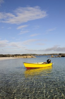 SCOTLAND, Argyll, Isle Of Mull, Yellow boat anchored in clear waters