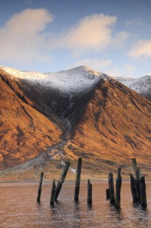 Scotland, Argyll, Loch Etive, Disused jetty with snowy mountains (Ben Starav)