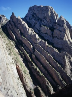 SPAIN, Catalonia, Lleida, Near vertical strata of crumbling limestone rock along Rio Noguera