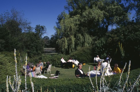 ENGLAND, East Sussex, Glyndebourne, Opera attendees enjoying picnics in the gardens during Opera