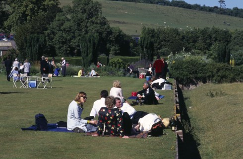 ENGLAND, East Sussex, Glyndebourne, Opera attendees enjoying picnics in the gardens during interval