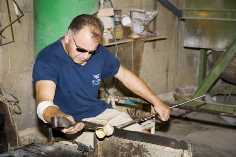 MALTA, Valletta Glass factory, Ta Qali Craft Village, Glass blower manufacturing a glass ornament.