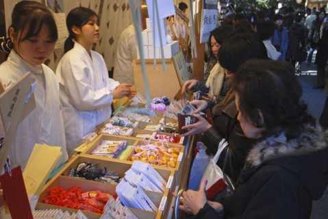 JAPAN, Honshu, Tokyo, "ingumae - Meijijingu shrine, New Years worshippers buying omamori good luck