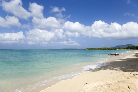 WEST INDIES, Grenada, Carriacou, Waves breaking on Paradise Beach at L'Esterre Bay with a fisherman