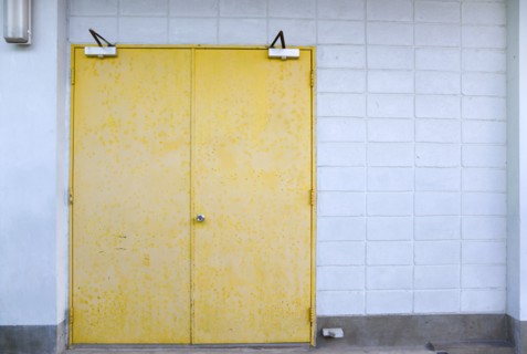 WEST INDIES, St Vincent & The Grenadines, Union Island, Closed metal yellow doors set in a white
