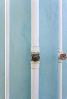 WEST INDIES, St Vincent & The Grenadines, Union Island, Three white pipes running down a turqoise