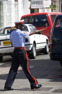 WEST INDIES, Grenada, St Georges, Corporal in the Royal Granada Police Force directing traffic at