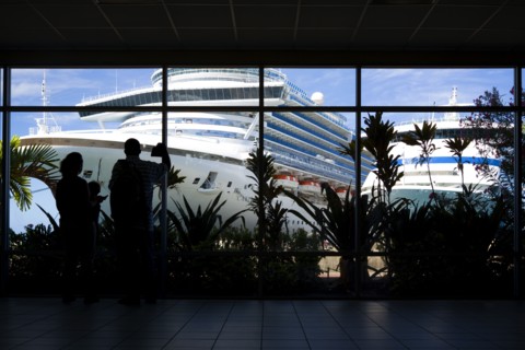 WEST INDIES, Grenada, St George, Tourists in the terminal building looking at the cruise ship