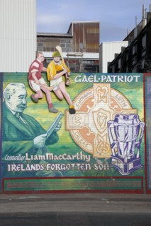 IRELAND, North, Belfast, "West, Falls Road. Mural depicting Liam McCarthy and some people playing