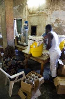 WEST INDIES, Grenada, St Patrick, Female workers hand bottling the rum at the River Antoine
