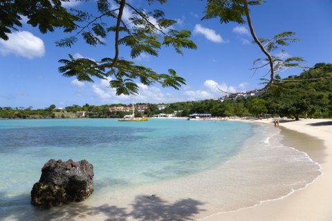 WEST INDIES, Grenada, St George, Gentle waves on BBC Beach in Morne Rouge Bay with tourists in the