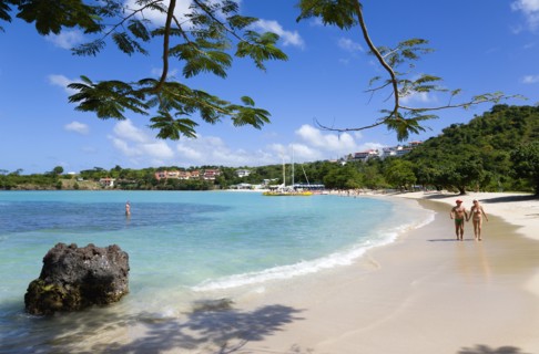 WEST INDIES, Grenada, St George, Gentle waves on BBC Beach in Morne Rouge Bay with tourists in the