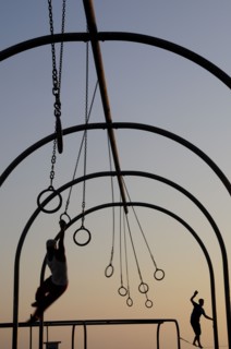 USA, California, Los Angeles, "Silhouetted Gymnasts on the rings, Santa Monica beach"