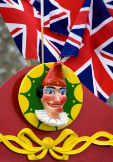 ENGLAND, West Sussex, Findon, Findon village Sheep Fair Bright red Punch and Judy stand with Union